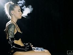 Cruel Anette smokes a cigarette and inhales deeply, she looks very sexy